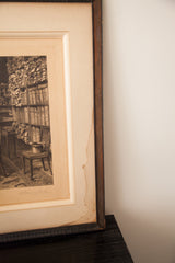 Close view of the antique etching's mat, showing discoloration next to the dark wooden frame.