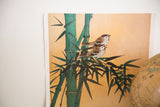 Close-up of two small birds on green bamboo against the lithograph's golden background.