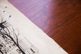 Vintage etching paper showing age, creases, blue paint drops, and the deckled edge.