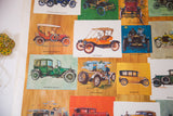 Colorful illustrations of antique cars on the vintage automobile poster's wood-grain background.