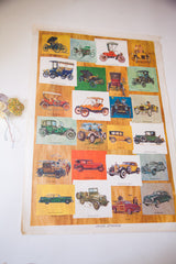 Angled view of the Antique Automobiles poster showcasing its grid of colorful car illustrations.