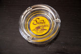 Close-up of clear glass vintage Sands Hotel ashtray showing Las Vegas, Nevada text.