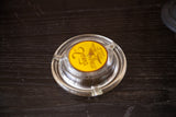 Clear glass vintage Sands Hotel Las Vegas ashtray with vivid yellow logo.
