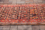 Vintage Persian Hamadan runner's distinct red, tangerine border and unusual charcoal field.