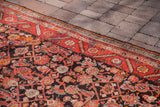 Vintage Hamadan runner's charcoal field with herati design, woven birds, and red-orange border.