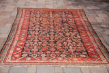 Vintage Hamadan with unusual charcoal field, geometric herati pattern, and red-orange border.