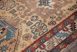 Geometric tribal patterns in teal, madder red, and gold on an antique Northwest Persian runner.