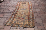 Earthy antique Karaja runner: gold field, geometric patterns in teal, madder red, and burgundy.