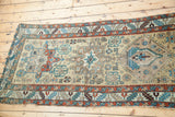 Antique Karaja runner border with geometric patterns in teal, rust, and beige tones.