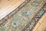 Antique Northwest Persian runner with geometric tribal patterns in teal, rust, and gold field.