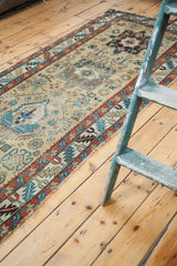 Aged geometric border and field detail of the antique Northwest Persian runner in teal, madder red, and gold.