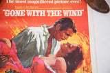 Vivid 70s Gone With the Wind poster, Rhett and Scarlett embrace in fiery reds.