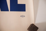 Blue union lithographers label on the creased cream edge of the We Like Ike political poster.