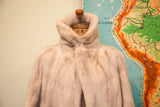 Vintage ivory mink fur coat with high collar and front closure.