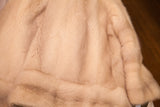 Vintage ivory mink fur coat with soft, subtly striped texture.