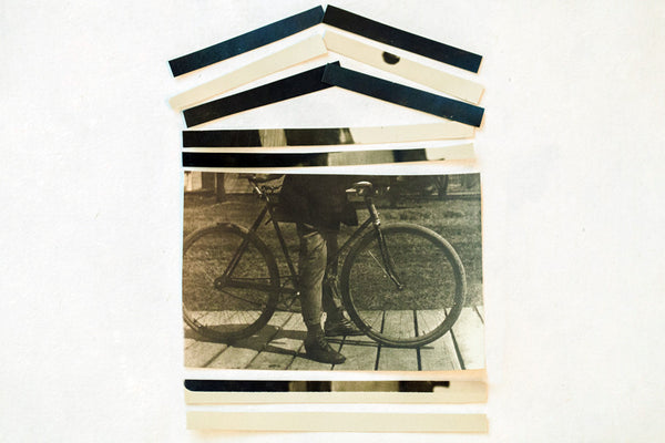 Close-up of the layered paper strips creating the roof of the antique bicycle photograph collage.