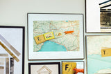 The 'F is for Fox' alphabet print framed in black and displayed on a gallery wall.