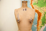 Vintage JR Bauman dress form with neck label and torn canvas on shoulders.