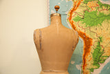 Back view of vintage JR Bauman dress form with peeled canvas shoulders and waist tie.