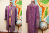 Back view of vintage purple Andre Laug coat with intricate floral pattern and detailed cuffs.