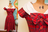 Vintage 1950s red and grey plaid day dress, oversized white collar, bow, front buttons.