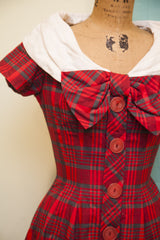 Vintage 50s day dress bodice with big red plaid bow and round red buttons.