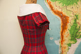 Back view of vintage 50s red and grey plaid dress, oversized white collar, metal zipper.