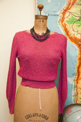 Textured knit fabric and gathered waist of the vintage pink Cashin sweater.
