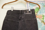 Versace Jeans Couture label on vintage faded acid wash black high-rise jeans.