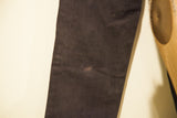 Close-up of Versace faded black denim with a slight circular mark.