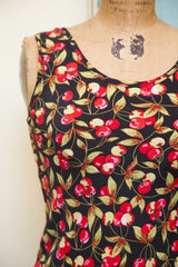 Smooth black vintage Betsey Johnson dress fabric with red cherries and green leaves.
