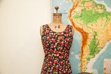 Vintage Betsey Johnson black dress, sleeveless with vibrant red cherry pattern.