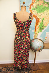 Rear view of a Vintage Betsey Johnson black dress, allover red cherry print.