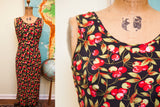 Iconic red cherry and green leaf pattern on black Betsey Johnson dress.