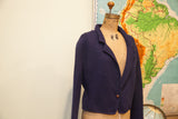 Right side view of vintage navy blue wool sweater jacket with single wooden button.