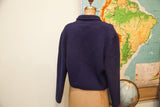 Back view of a vintage navy blue wool slouchy sweater with a wooden button.