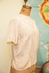 Vintage 50s ivory pink silk blouse, back view with embroidered applique and buttons.