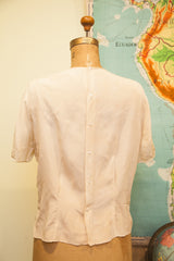 Ivory pink Vintage Tailored Woman silk blouse back, with vertical button closure.