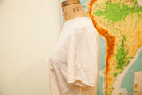 Dainty applique embroidery on the short sleeve of the vintage ivory silk blouse.