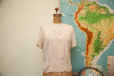 Tailored Woman vintage silk blouse in ivory pink, with intricate white embroidered neckline.
