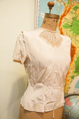 Lower front of vintage 40s Mel Hahn blouse with light stains at hem.