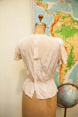 Vintage 40s blouse back with button placket and sculpted lower hem.