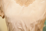 Detail view of vintage 40s blouse in light beige rayon, showing light stains.