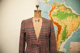 Vintage Armani blazer's collarless V-neck, red and black houndstooth, single button.