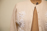 Intricate white floral beading and pearl buttons on vintage ivory cashmere sweater.