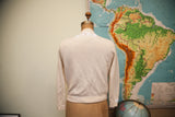 Back of ivory 1950s cashmere sweater, with delicate white floral neck and cuff beading.