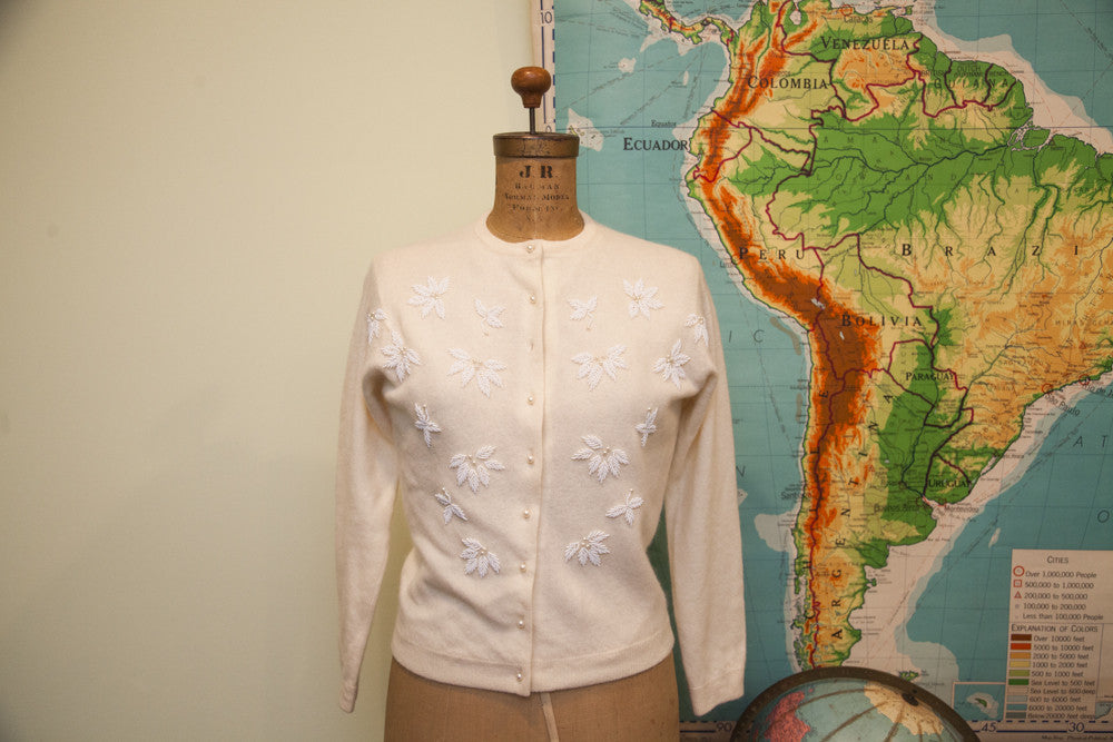 Vintage 50s ivory lambswool angora sweater with white beaded floral designs and pearl buttons.