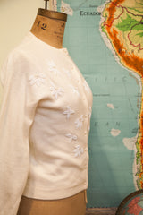 Soft ivory 1950s angora sweater featuring intricate white bead and pearl leaf patterns.