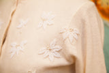 Textured ivory lambswool angora sweater with delicate white beaded leaf motifs and pearls.