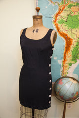 Scoop neckline and white side buttons of the vintage Betsey Johnson black dress.